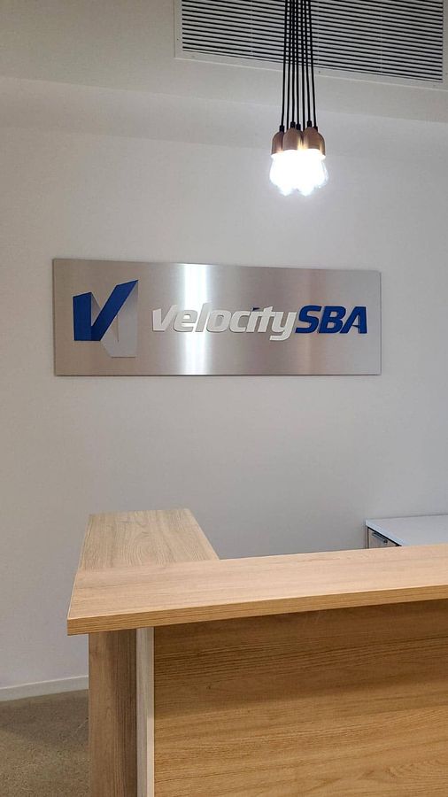 Velocity SBA interior sign decorating the lobby wall