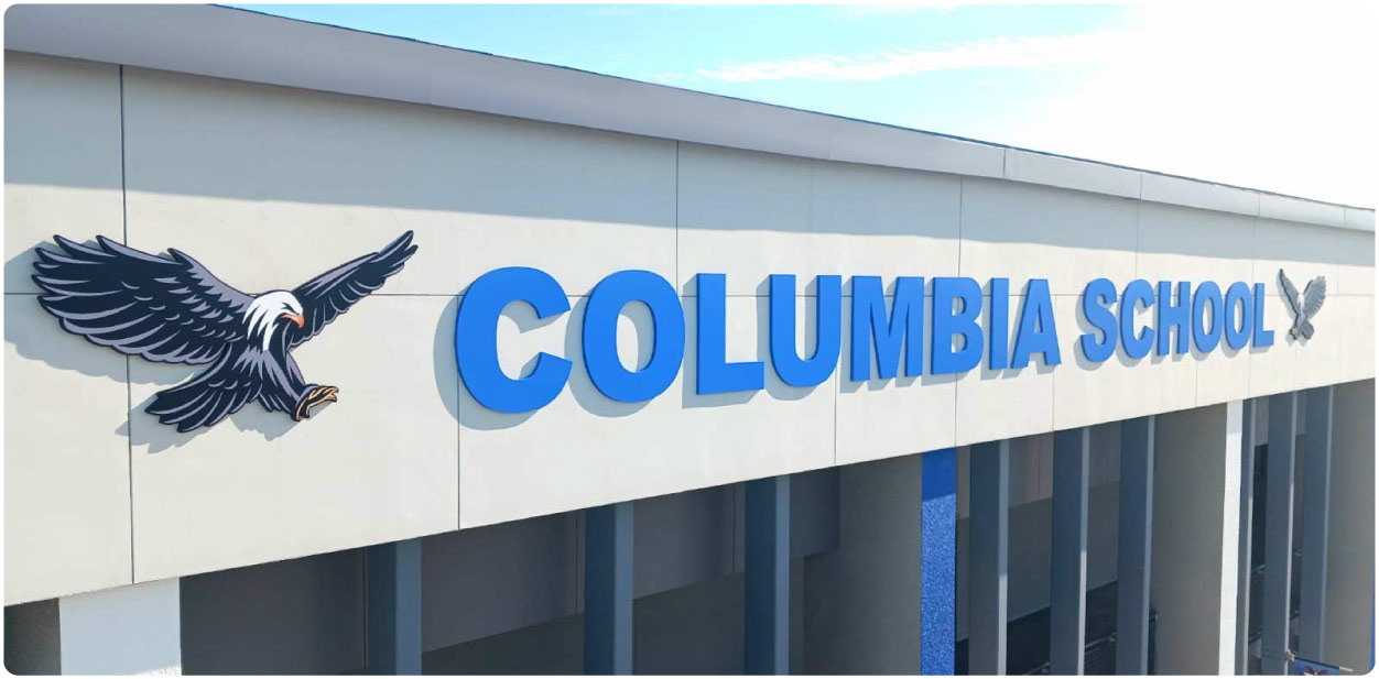 Columbia School large branding design in blue featuring the school name along with eagle logos