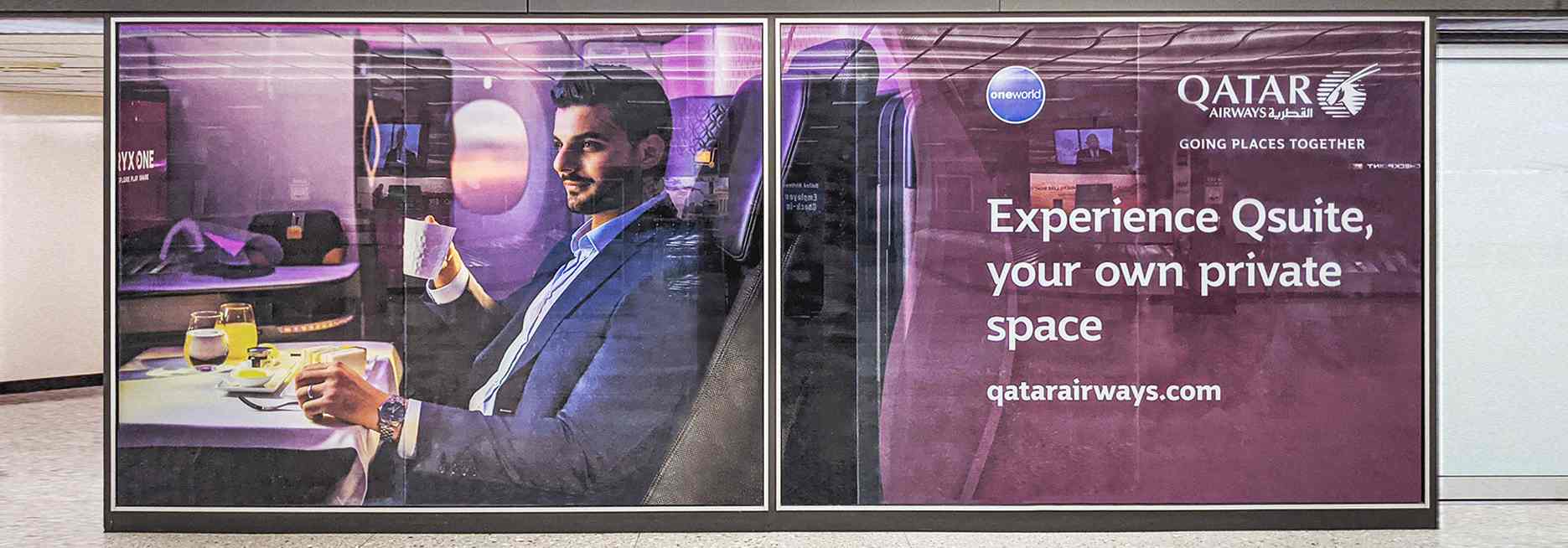 Qatar Airways feature wall design in purple displaying the company's motto