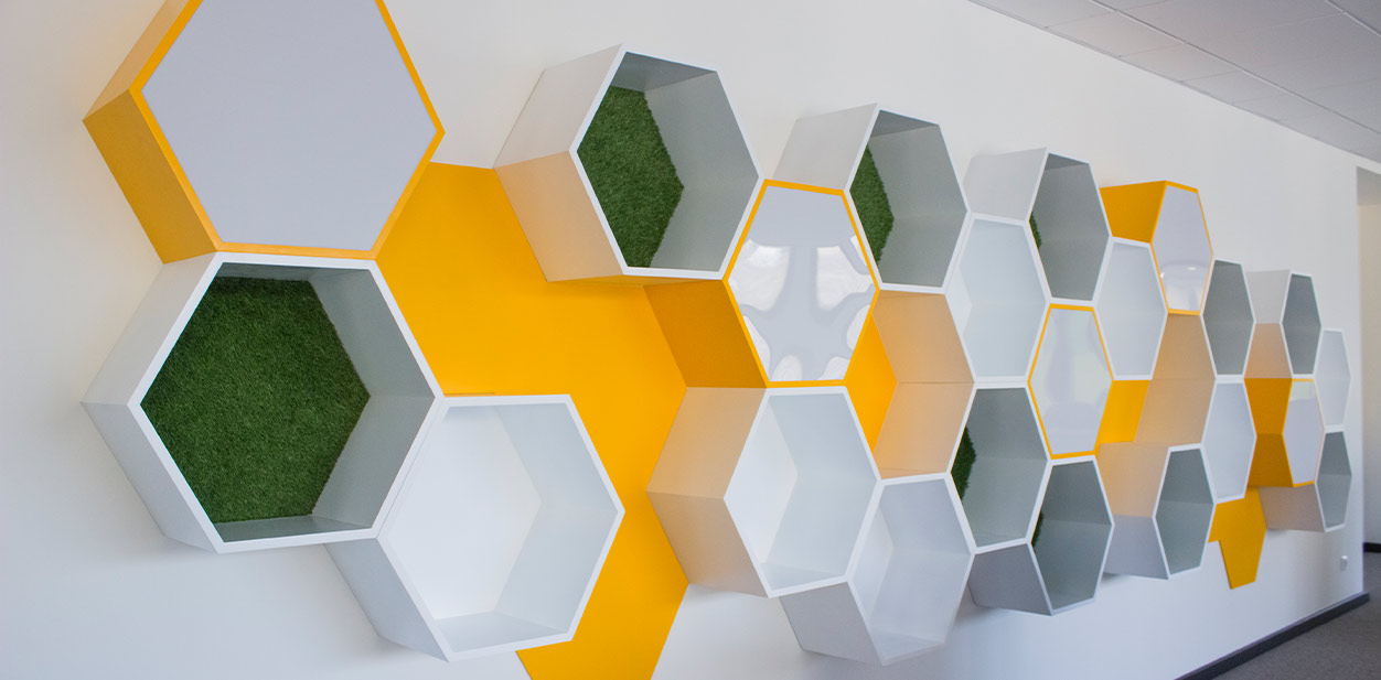 Colorful geometric accent wall design with green, yellow and white structures