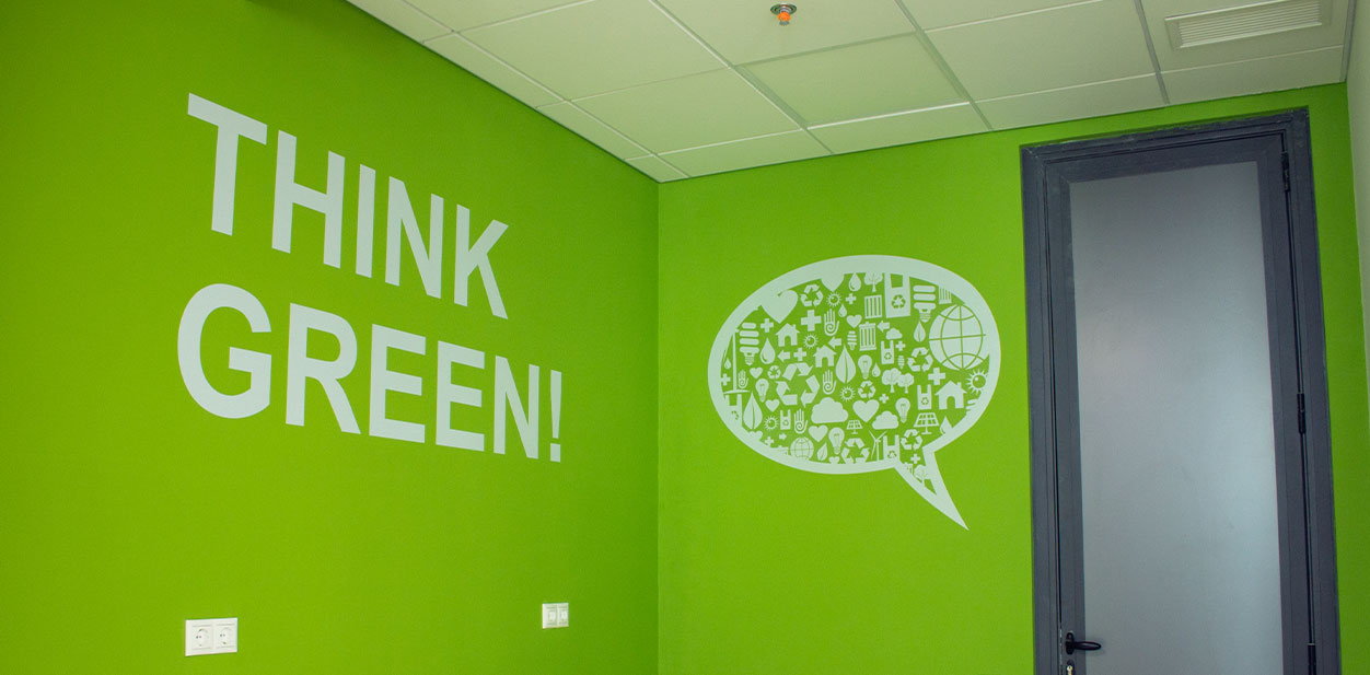 Green accent wall design displaying the phrase Think Green and a comment icon