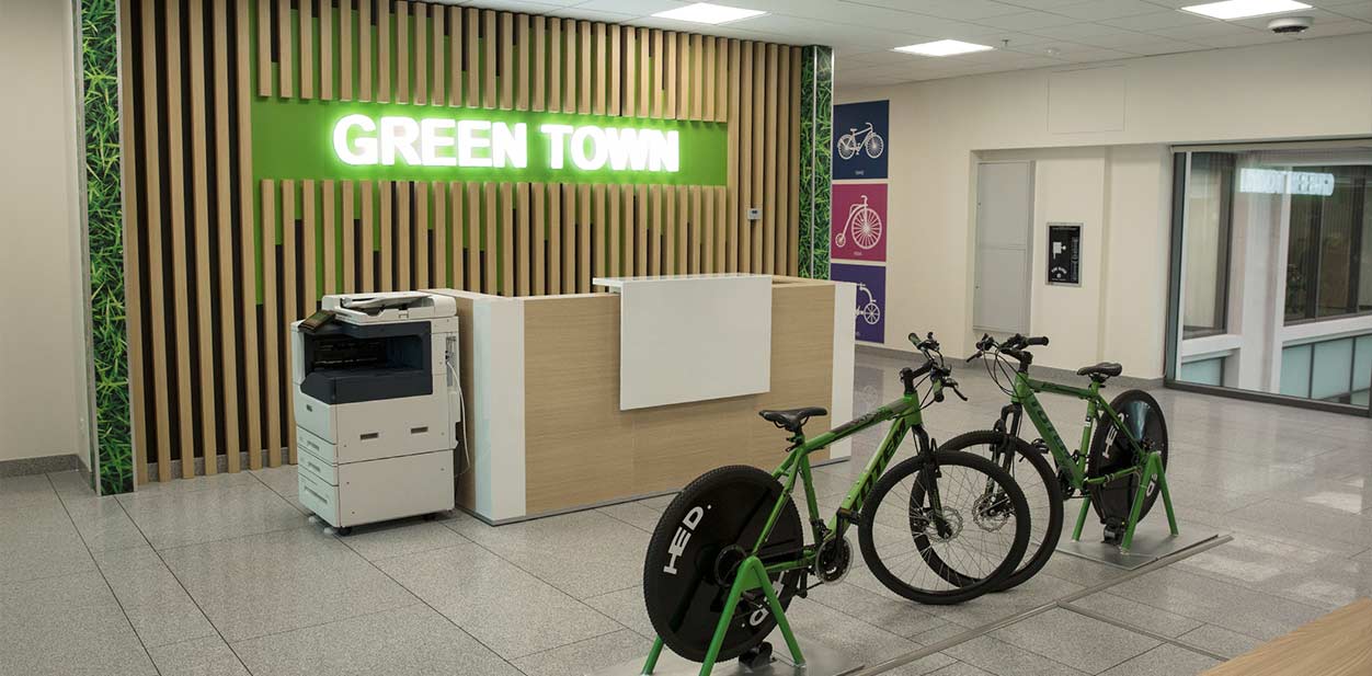 Green Town feature wall design in an illuminated style with wood and green materials