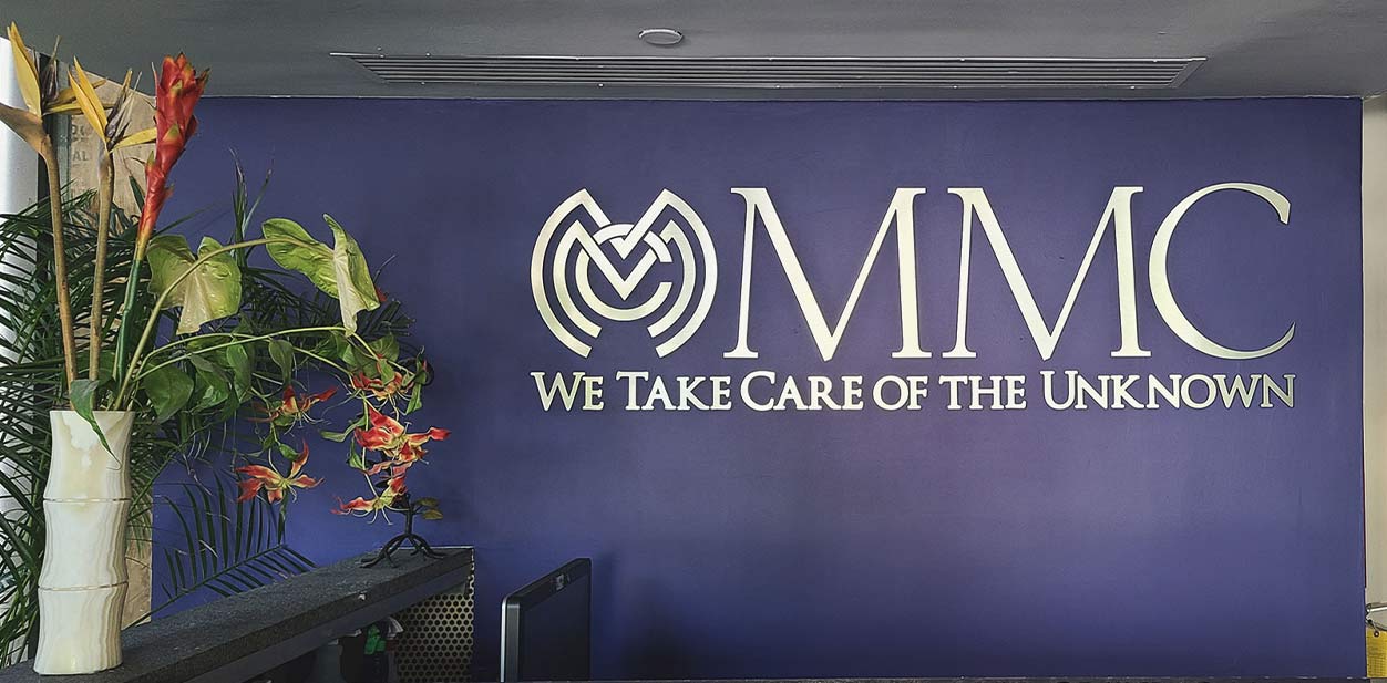 MMC feature wall design in deep purple displaying the brand name and slogan with white letters