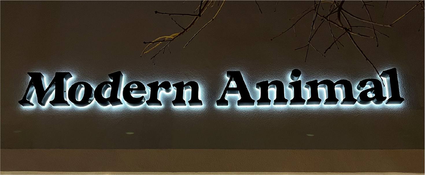 Modern Animal letter signage in black with halo lighting made of lexan and aluminum for design