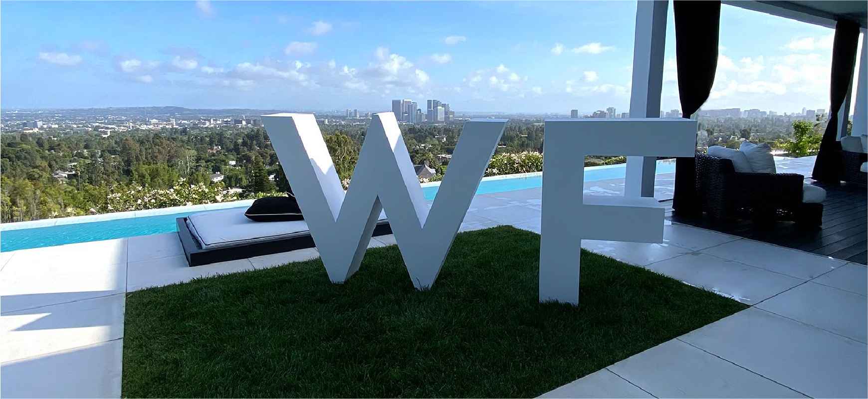 White Fox business letter sign showing the initials of the company's name made of aluminum