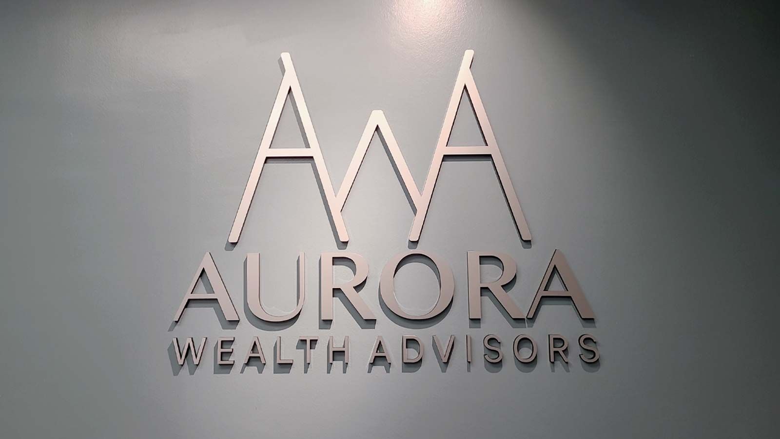 Aurora Health Advisors 3D sign attached to the wall