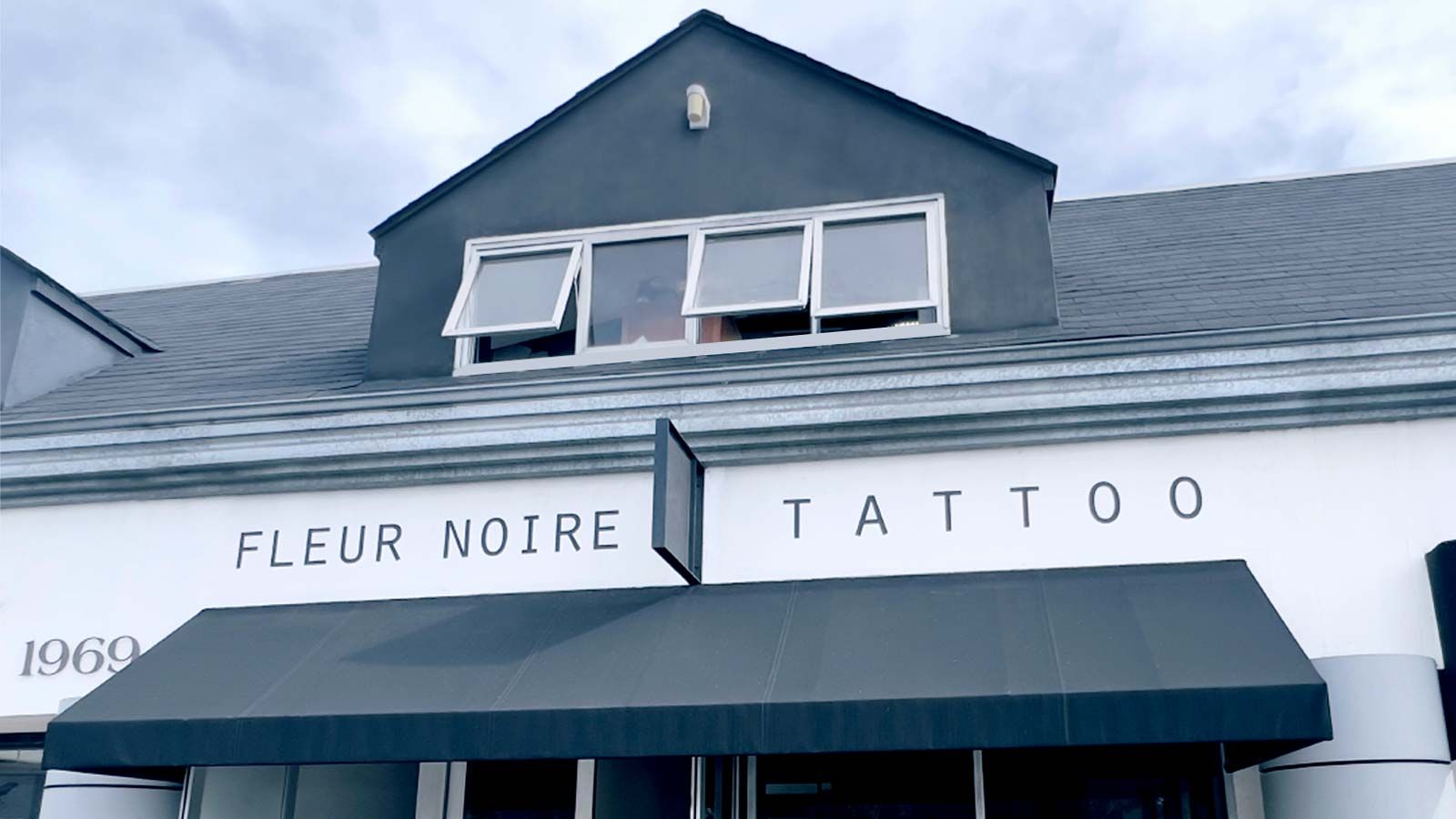 Fleur Noire Tattoo vinyl lettering applied to the building