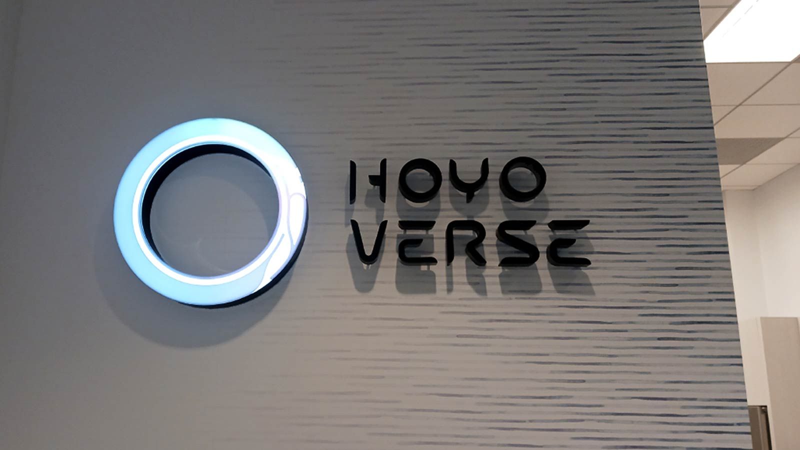 HoYoverse office sign mounted on the wall