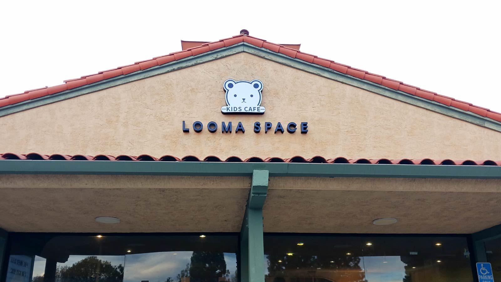 Looma Space 3D sign installed on the facade