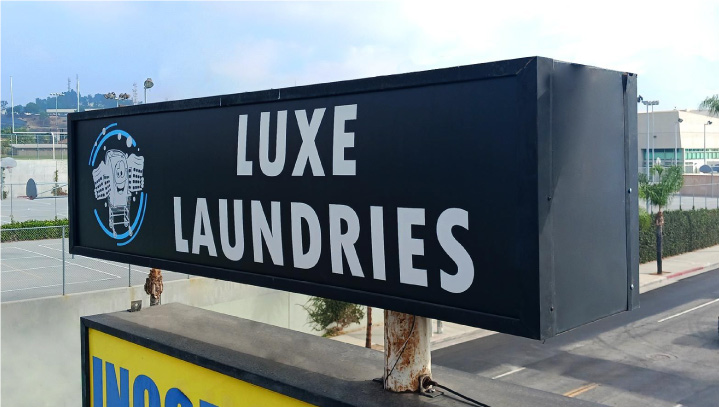 Luxe Laundries sign face replacement of a large black box display made of lexan for branding