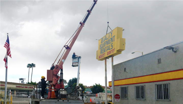 Quality Equipment Rentals sign replacement of an outdoor display with a crane supporting it