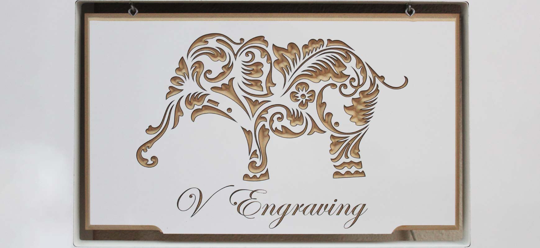 Sophisticated CNC engraving process on wood with text and an elephant silhouette