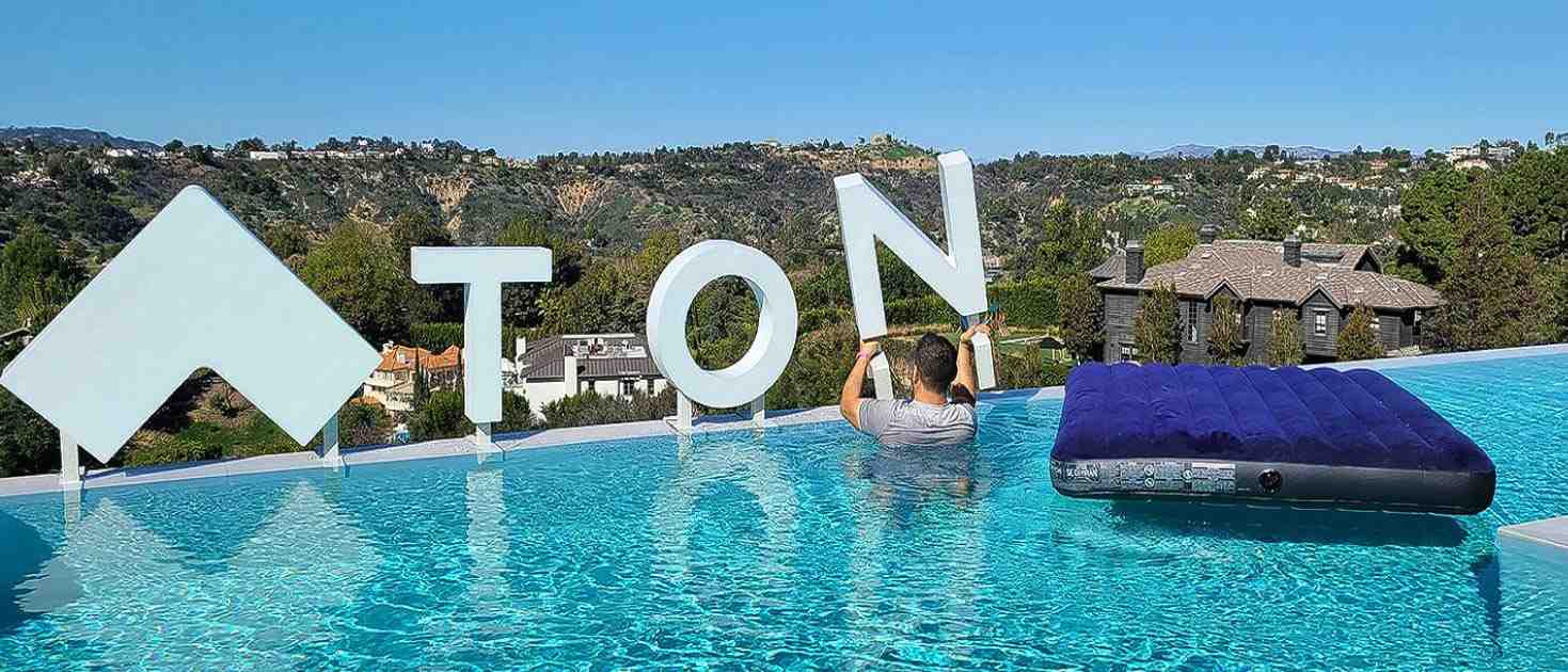 Tonal freestanding plastic channel letter installation on the edge of a pool