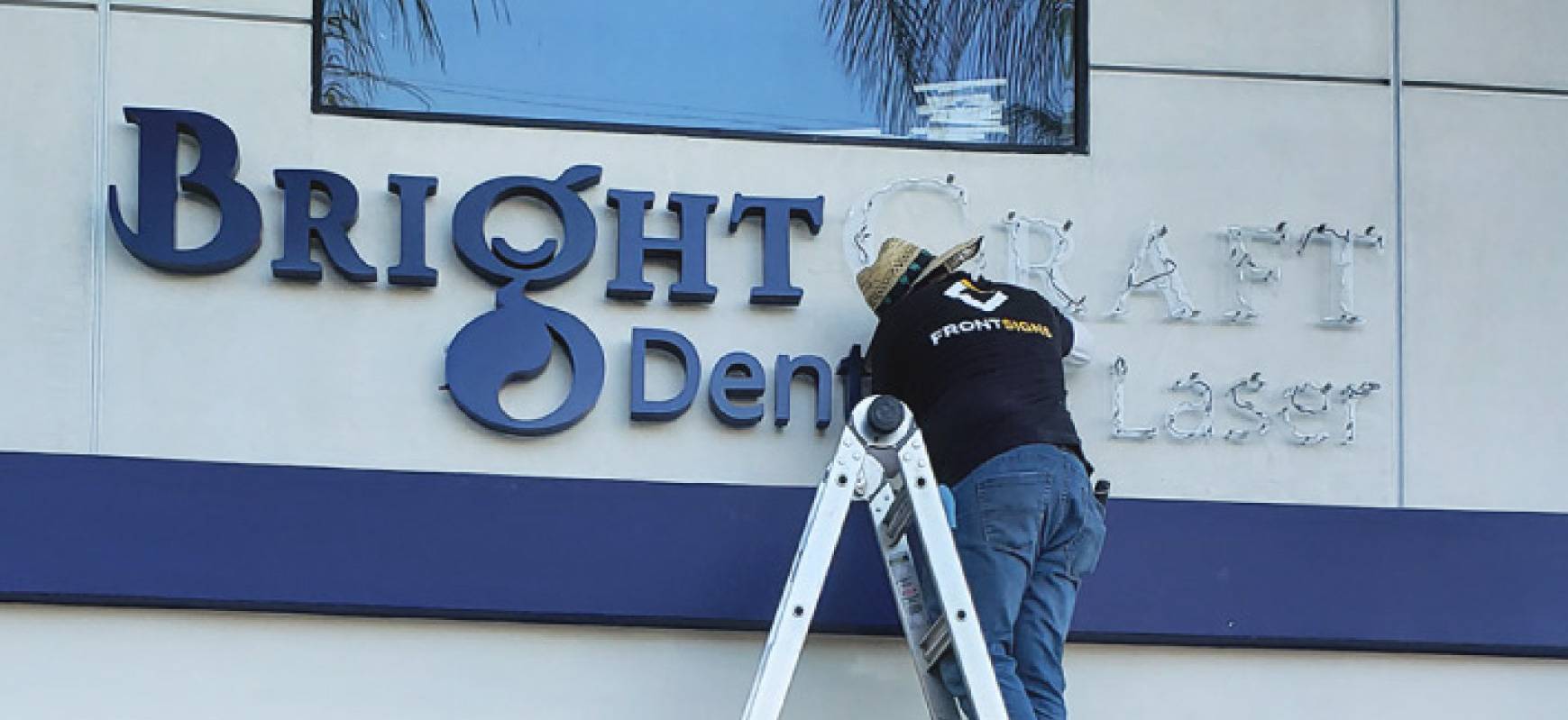 Bright Craft Dental and Laser sign installation process on an elevated surface