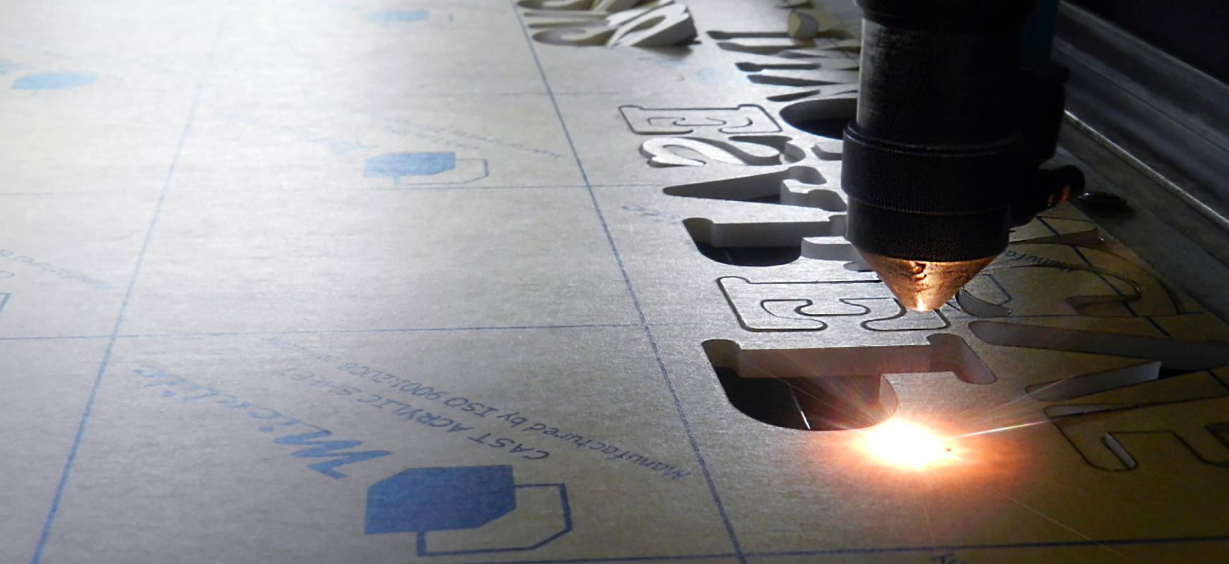 Acrylic laser cutting process for precise cut-outs while providing clear and clean-cut edges
