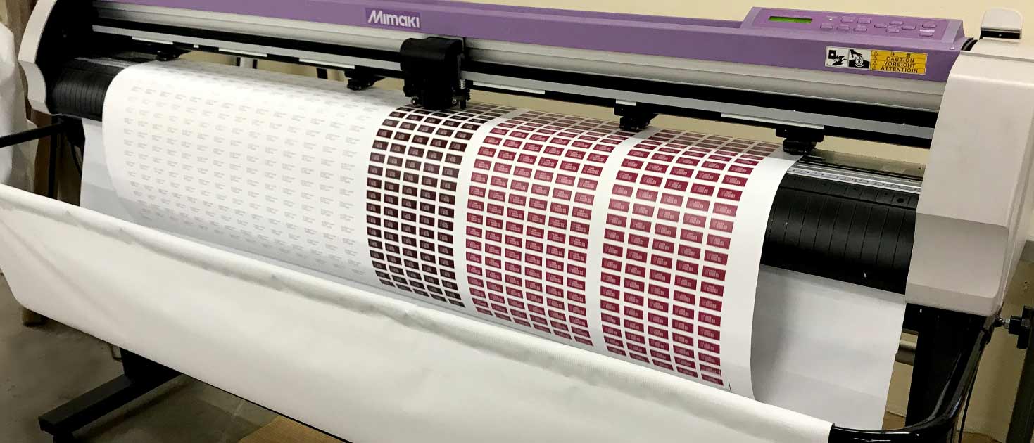 High-precision plotter contour cutting of adhesive graphics made of vinyl material for branding