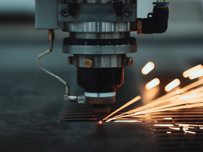 The process of laser cutting showing a high-precision technique on a rigid material