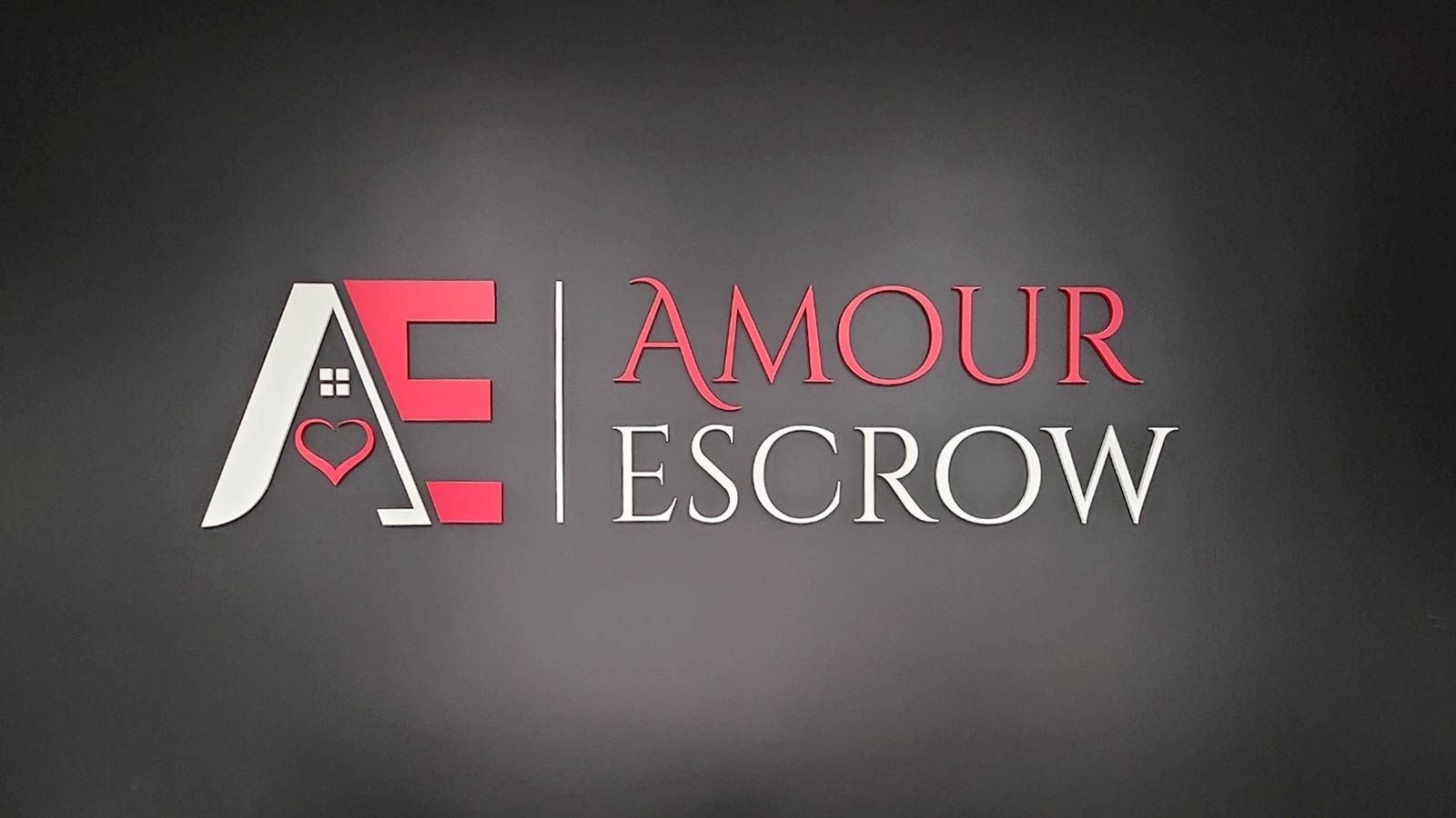 Amour Escrow custom letter sign mounted on the wall