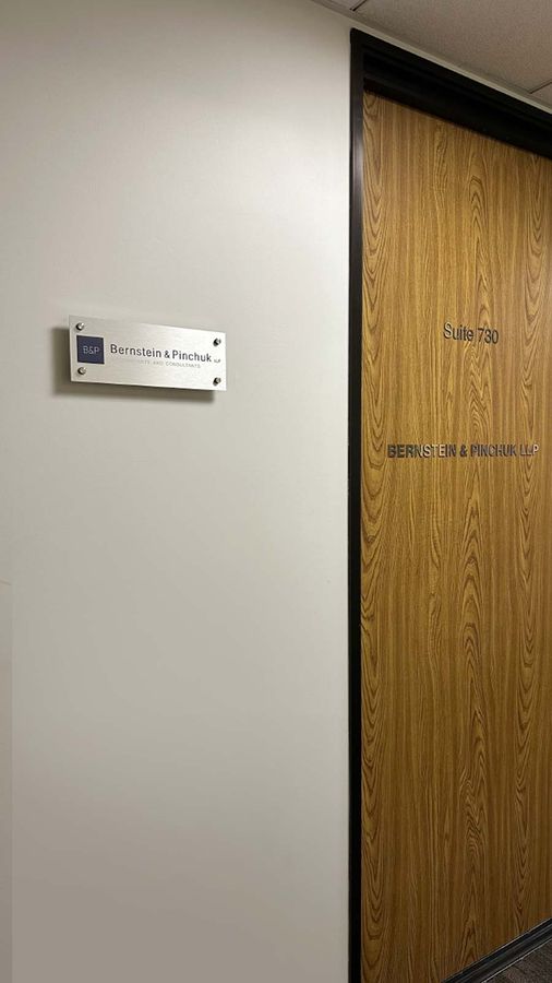 Bernstein and Pinchuk LLP office sign mounted on the wall