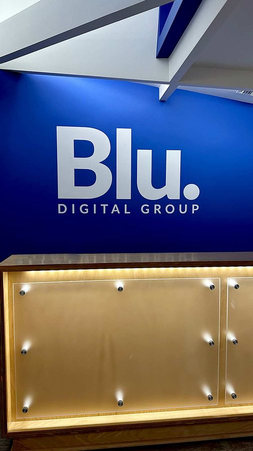 Blu Digital Group lobby sign attached to the wall