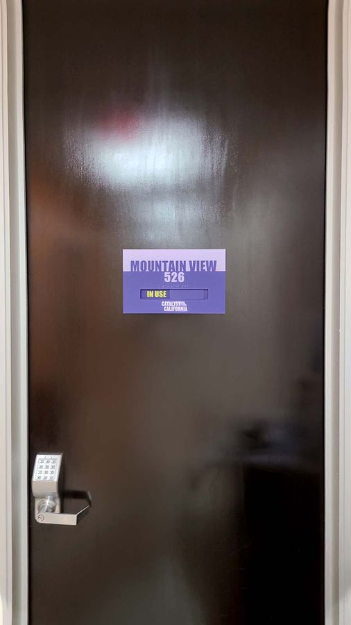 Catalyst California acrylic sign attached to the door