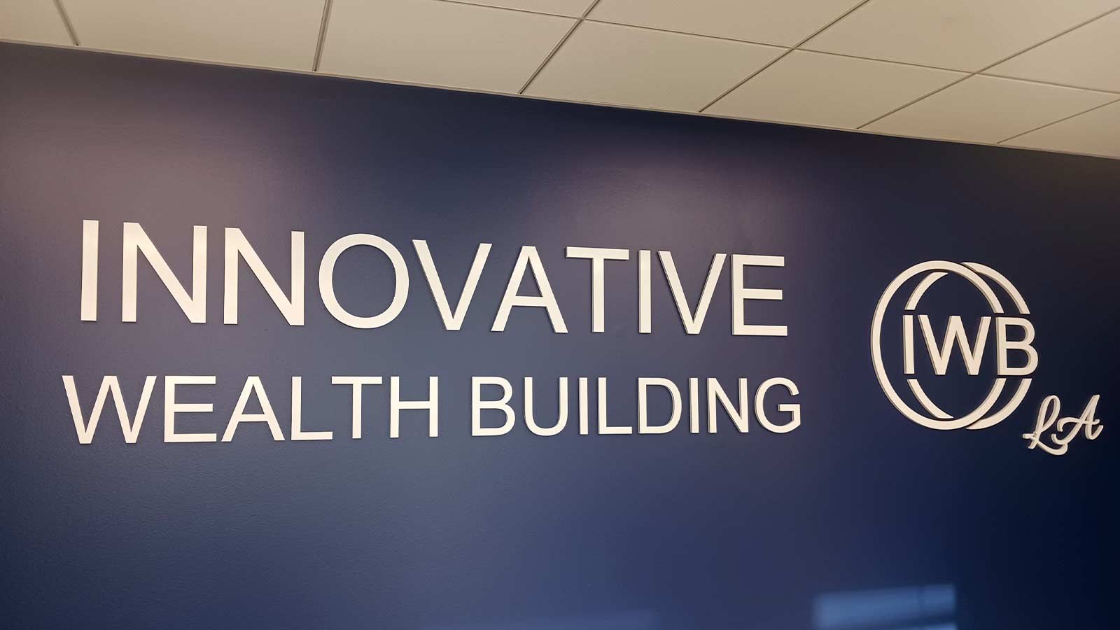 Innovative Wealth Building acrylic signs mounted on the wall