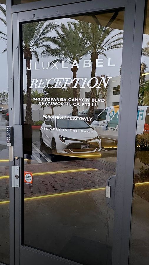 JLUXLABEL vinyl lettering attached to the door glass