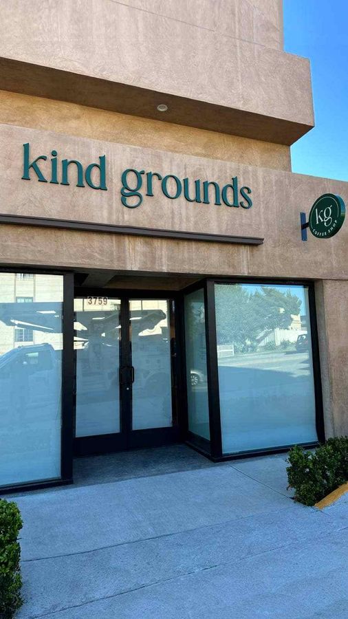 Kind Grounds logo signs installed at the storefront