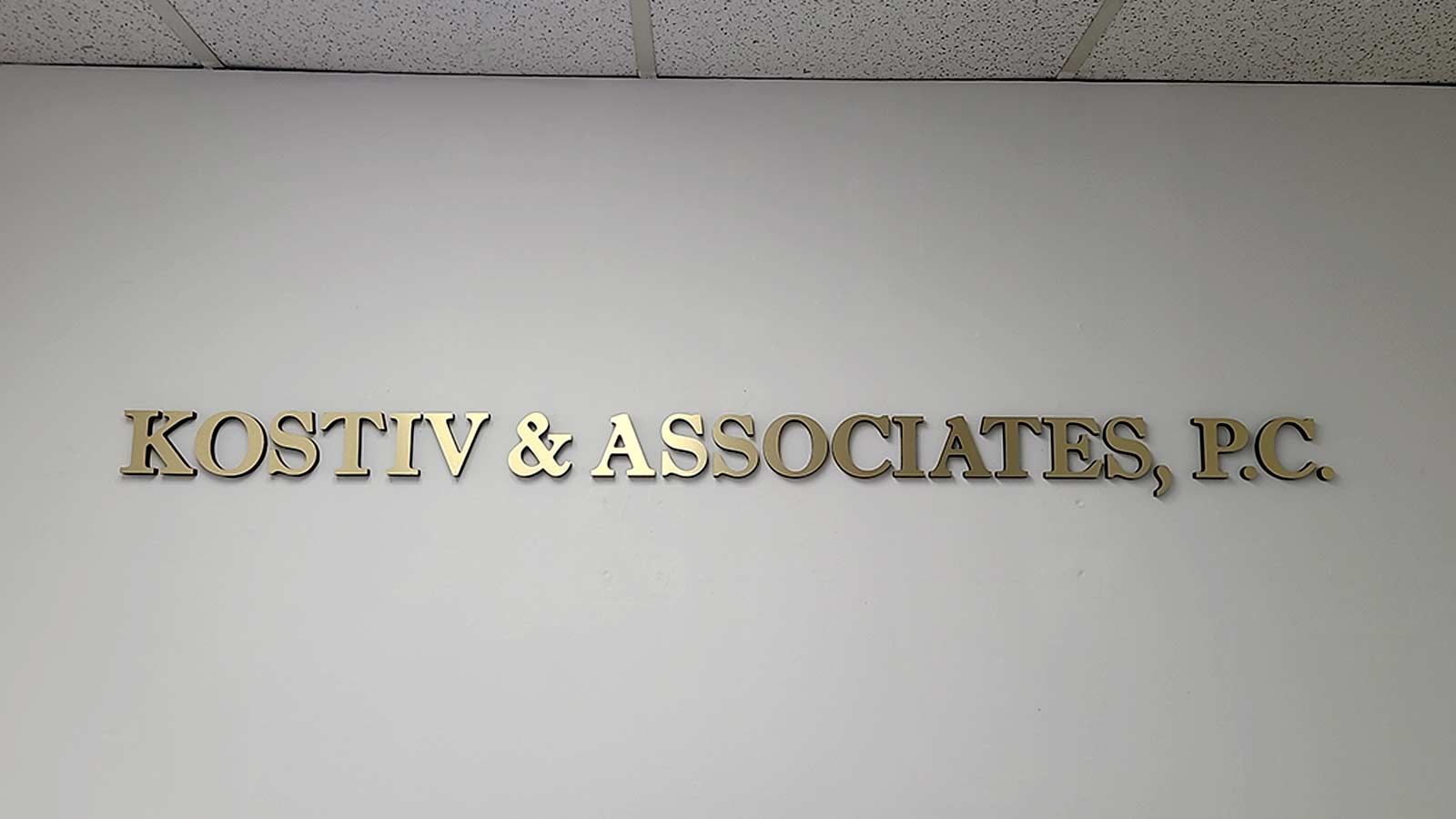 Kostiv & Associates, P.C. foam core sign on the wall