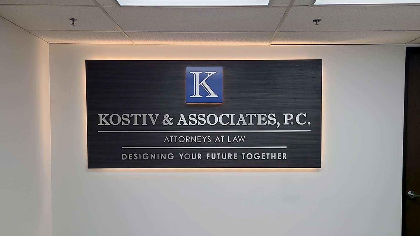 Kostiv & Associates, P.C. light up sign fixed to the wall