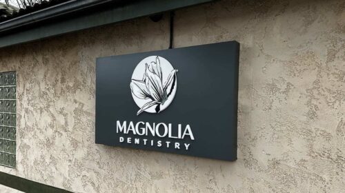 Magnolia Dentistry push through sign mounted on the building