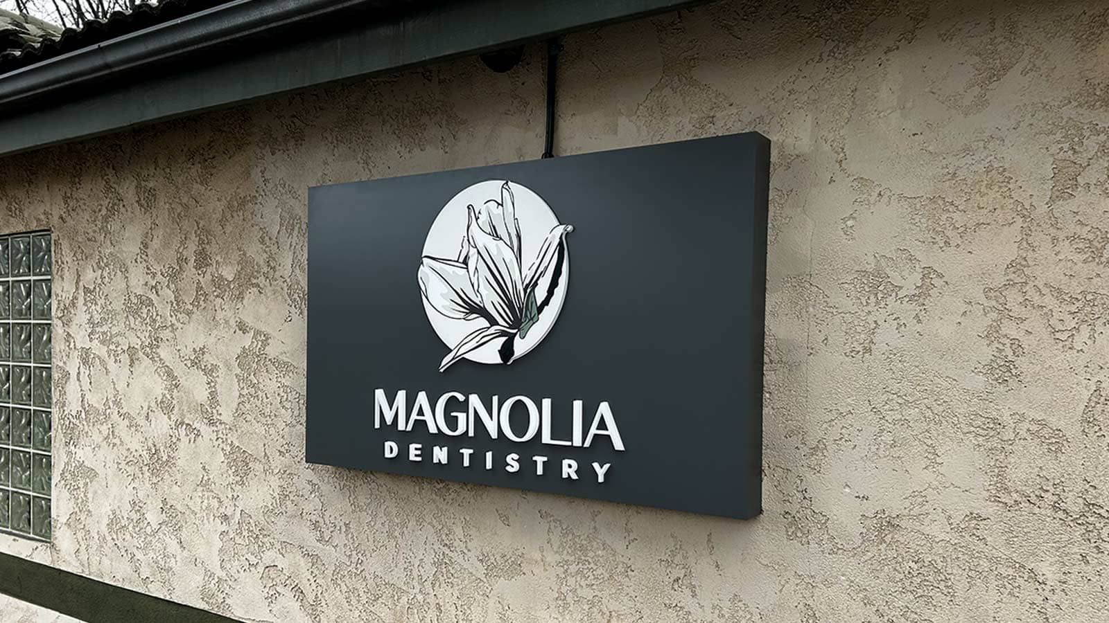 Magnolia Dentistry push through sign mounted on the building