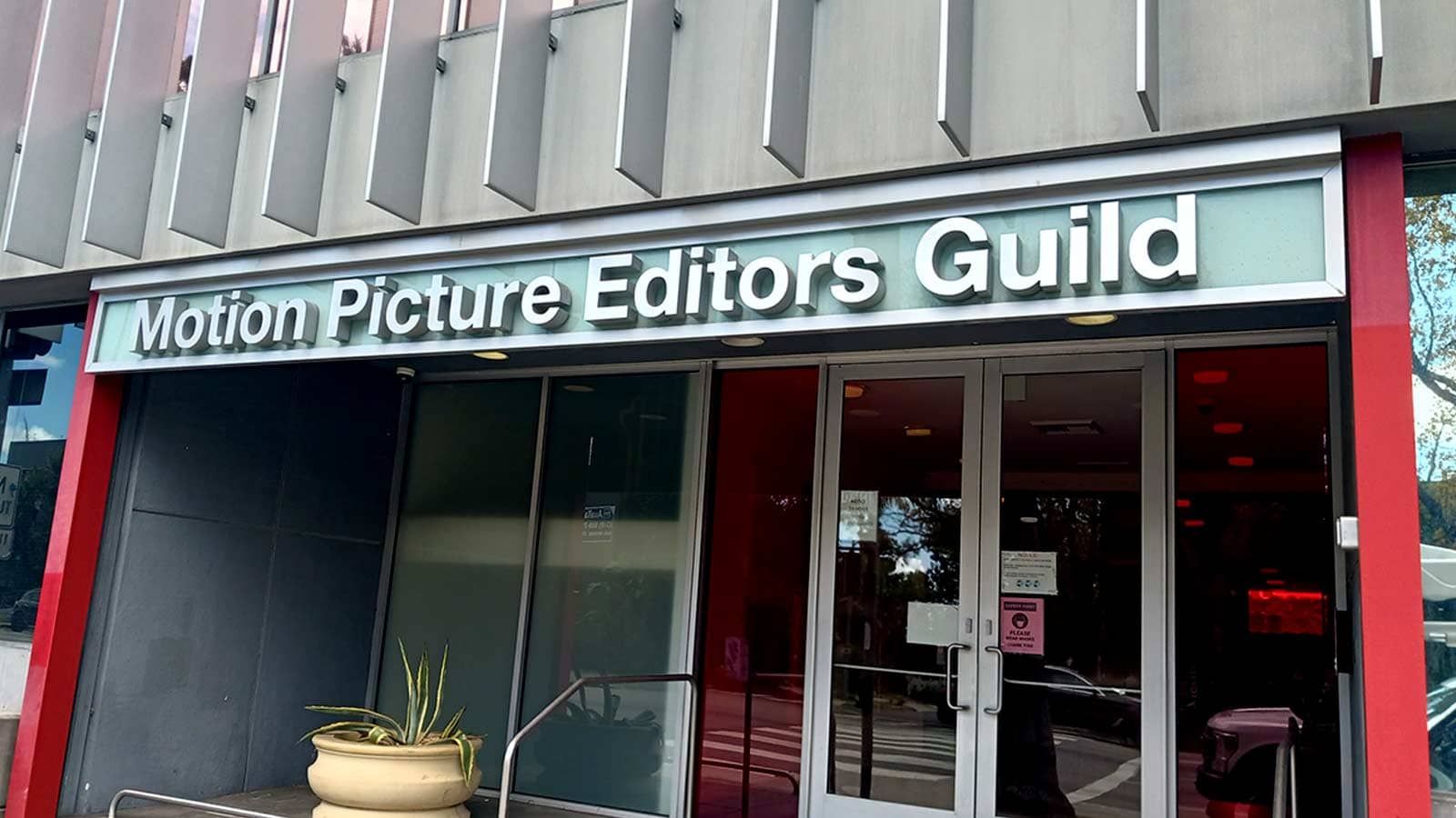 Motion Picture Editors Guild 3D sign attached outdoors