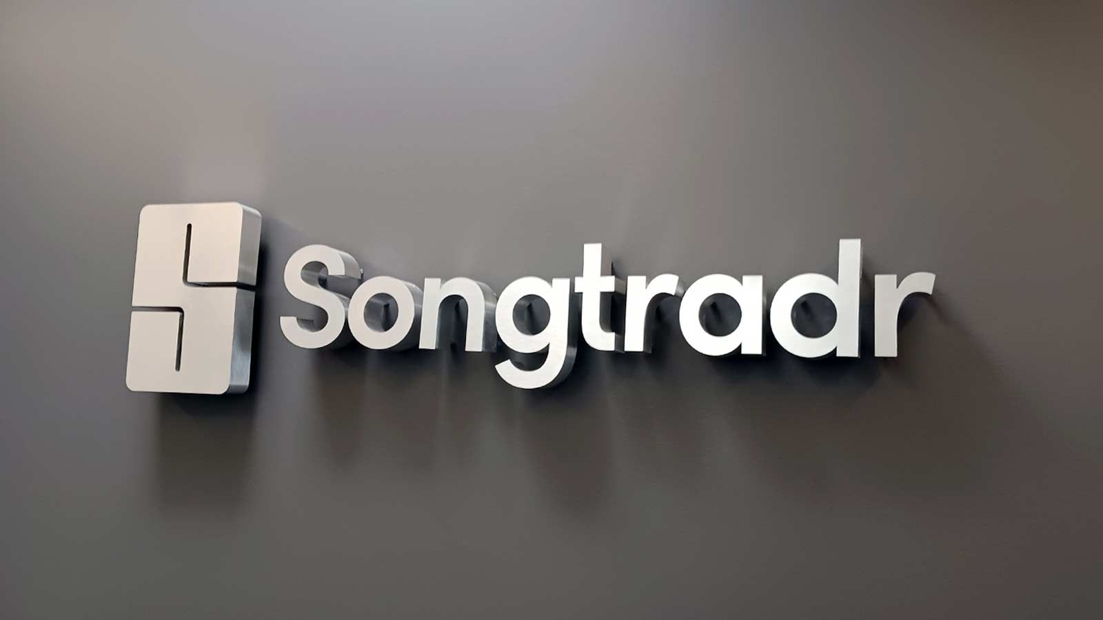 Songtradr Inc reverse channel letters attached to the wall