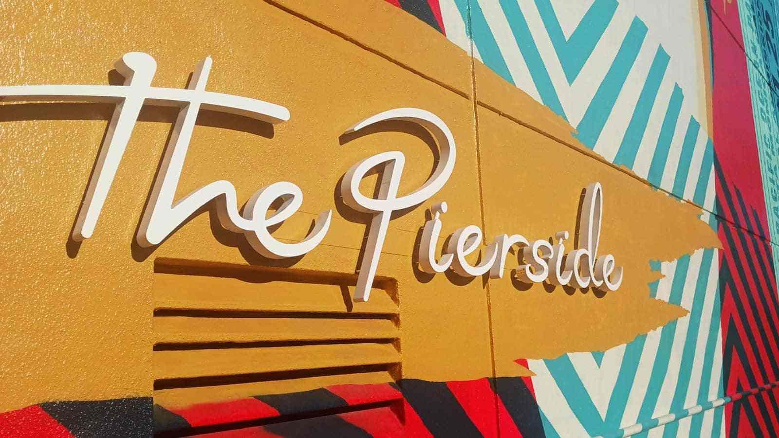 The Pierside logo sign mounted on the facade