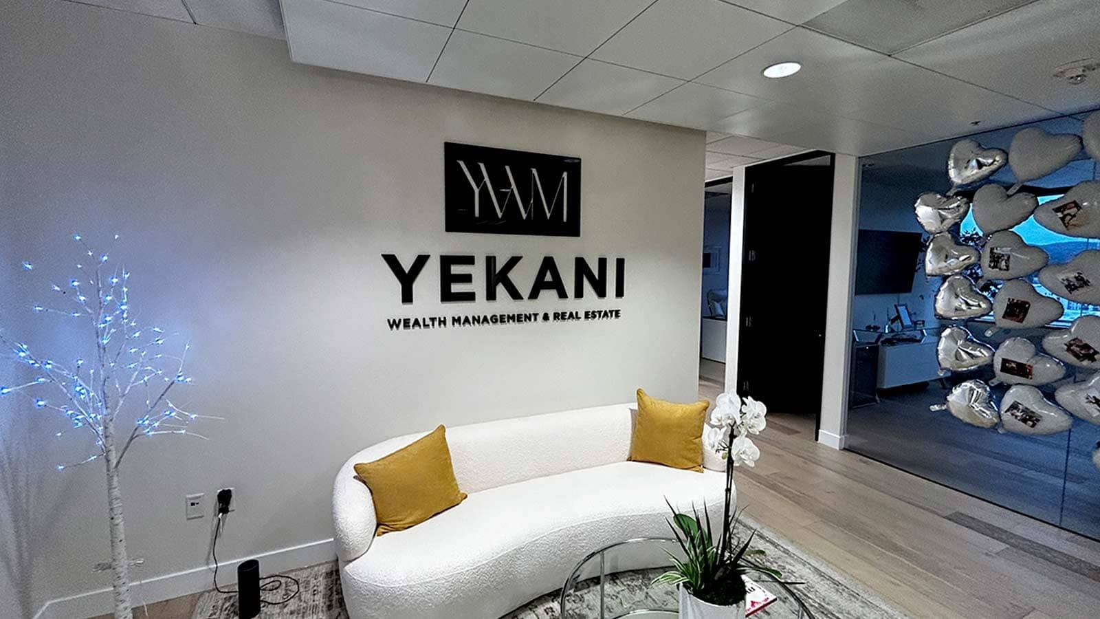 Yekani Wealth Management & Real Estate 3D sign on the wall