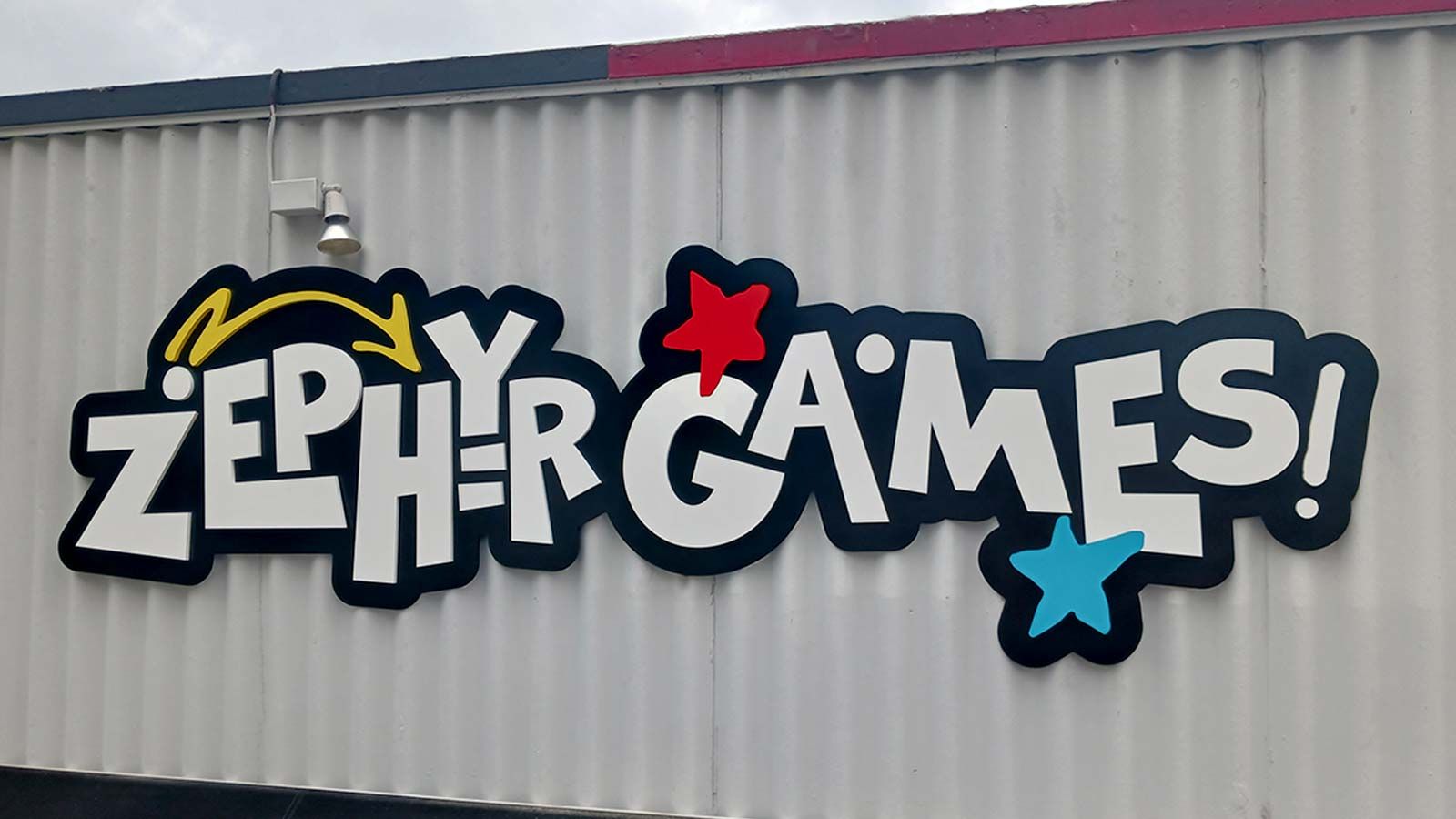 Zephyr Games logo sign set up outdoors