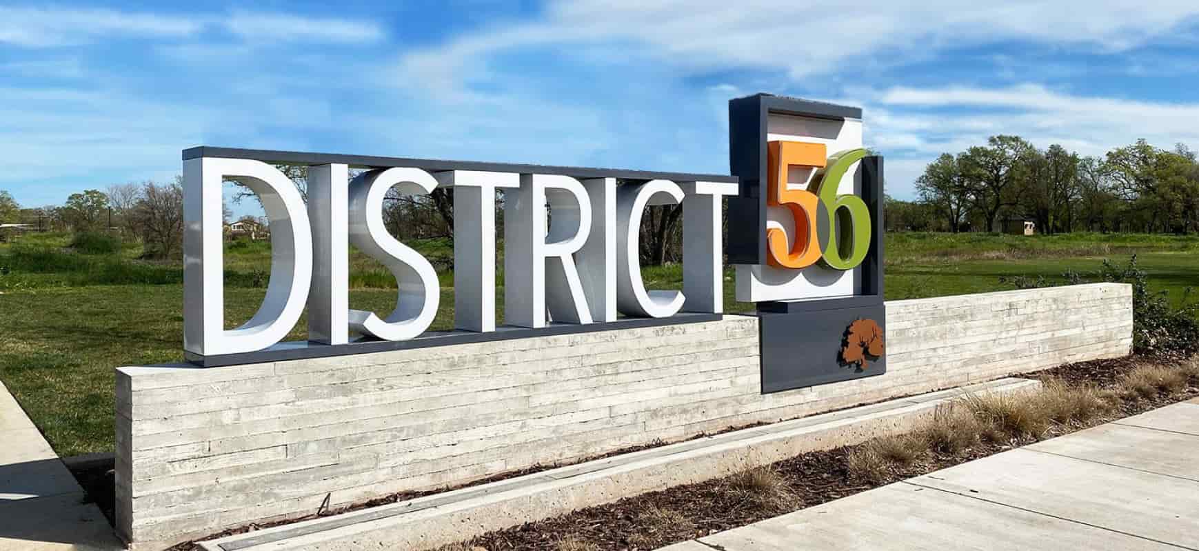 District 56 modern signage displaying the brand name and logo made of aluminum and lexan