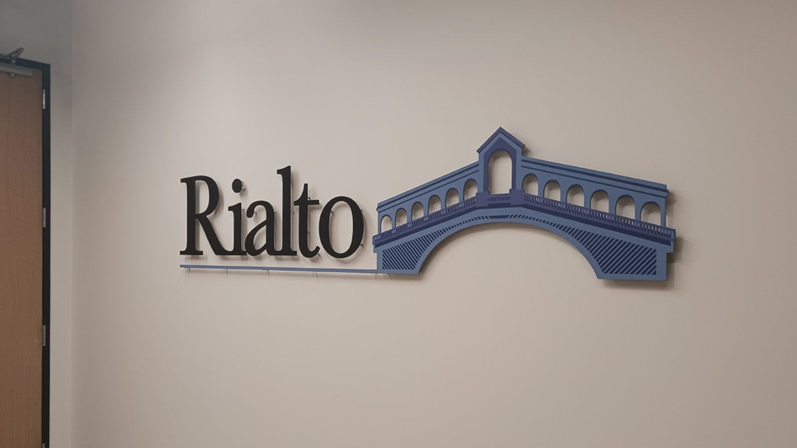 Rialto Capital 3D sign mounted on the wall