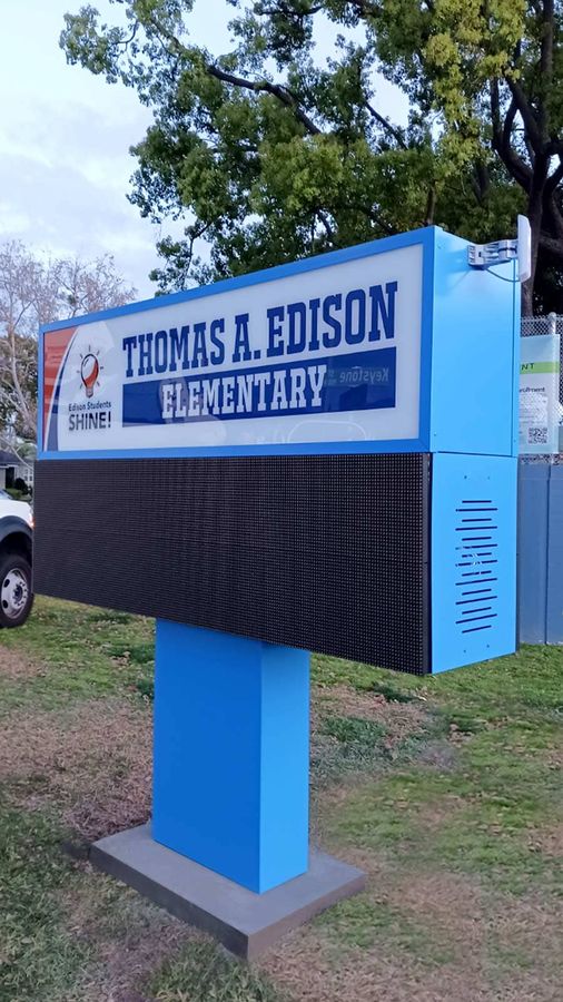 School outdoor sign installation by the road