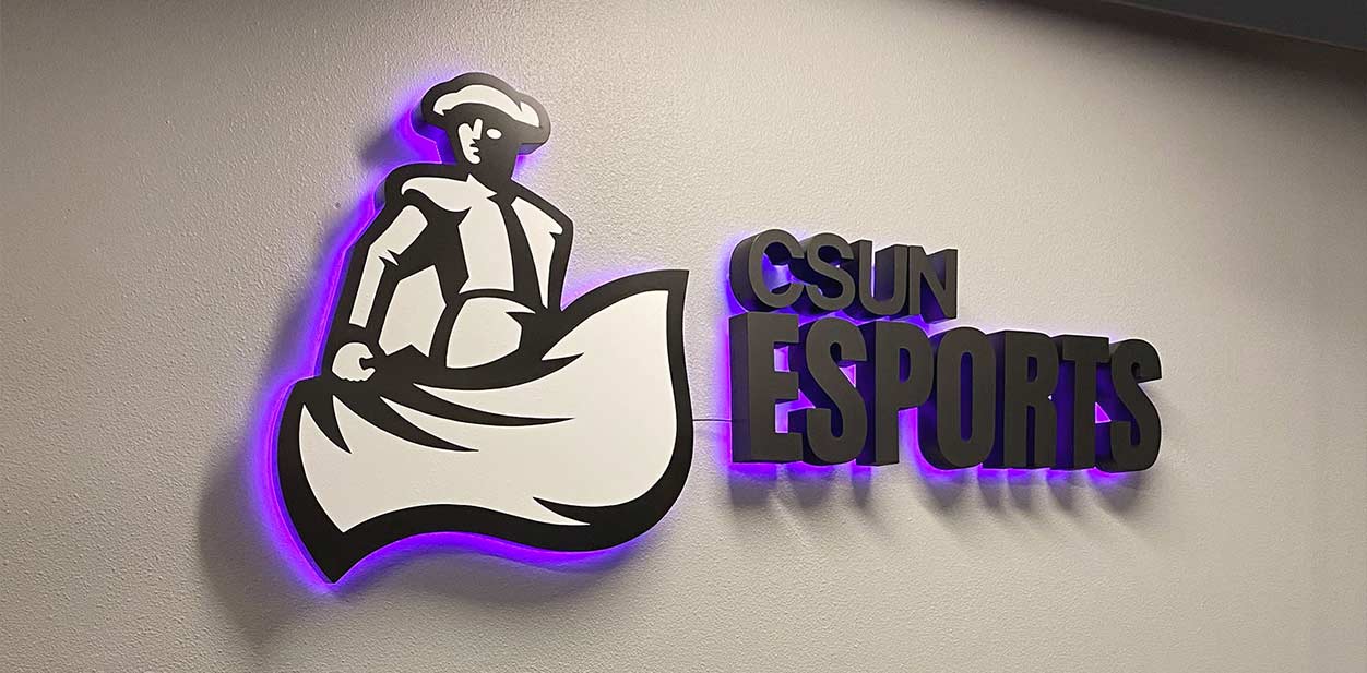 CSUN Esports backlit wall art featuring the brand name and logo for branding purposes