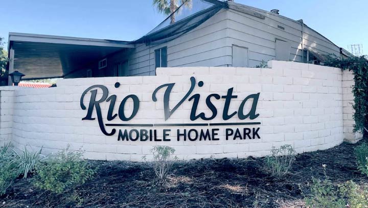 Rio Vista Mobile Home Park neighborhood signage displaying the community name made of aluminum