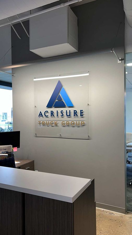 Acrisure Truck Group lobby sign attached to the wall