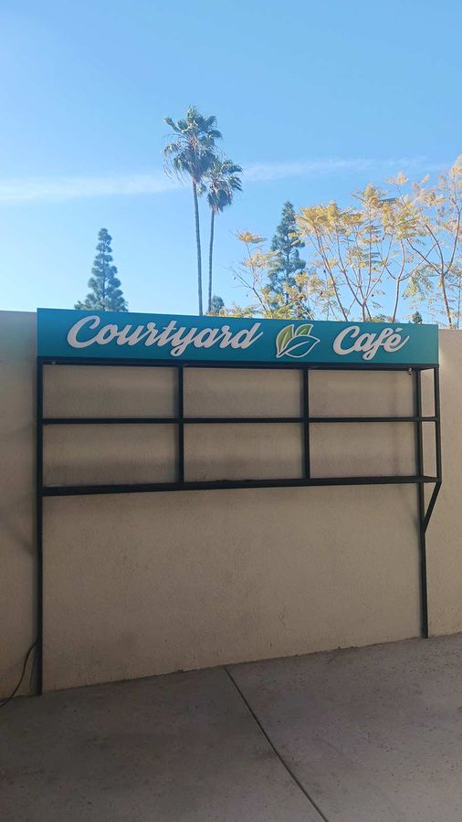 Courtyard Cafe push through sign installed outdoors