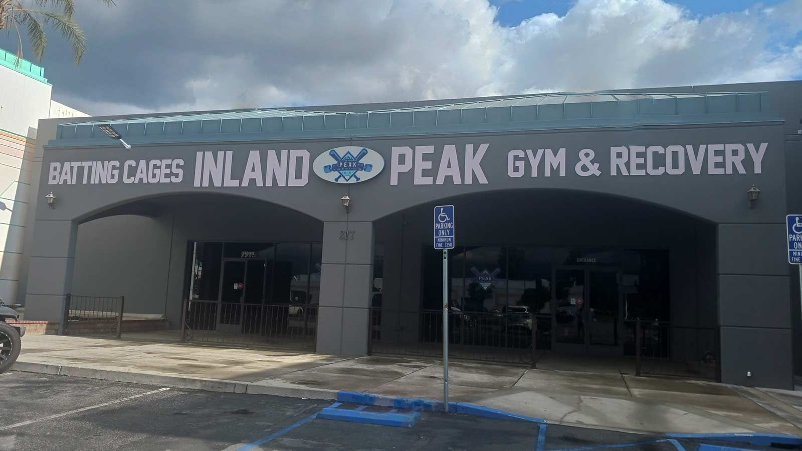 Inland Peak PVC sign mounted on the facade