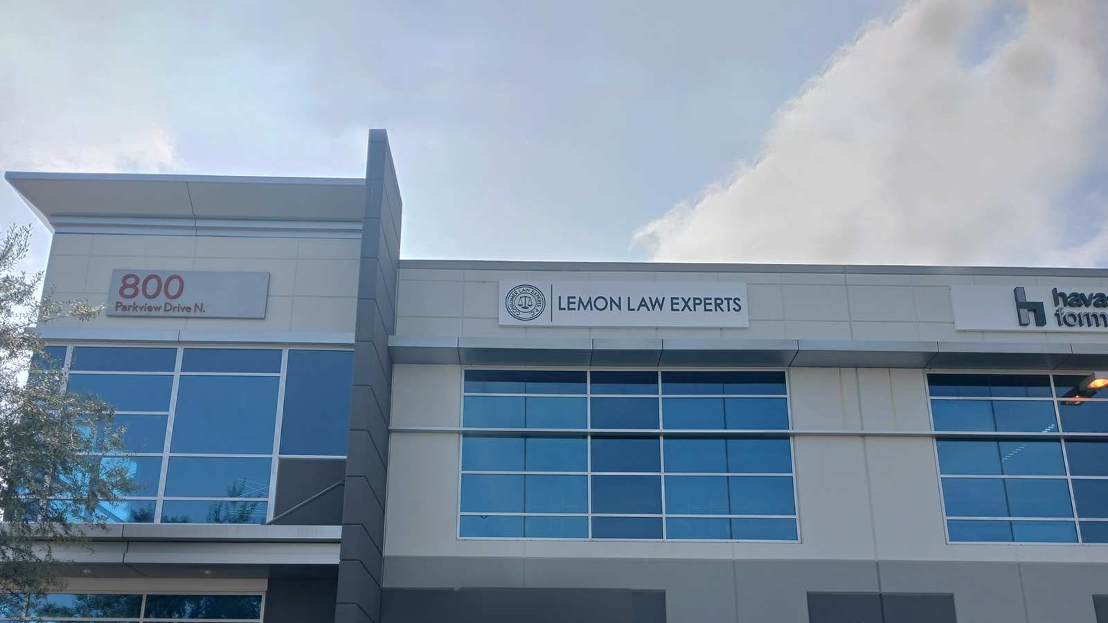 Lemon Law Experts logo sign mounted on the building