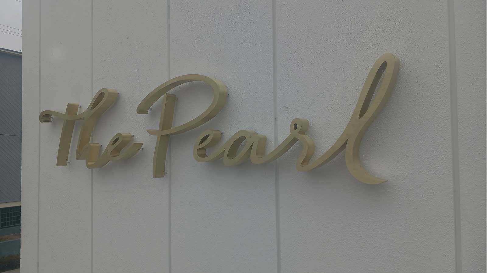 Pearl Equity Partners 3D signs attached to the wall