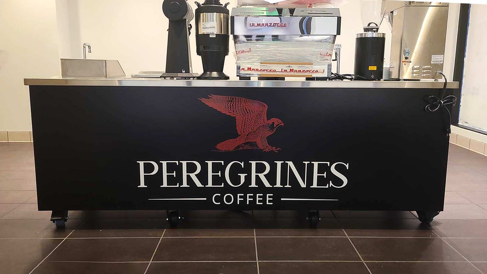 Peregrines Coffee custom decal attached to the bar