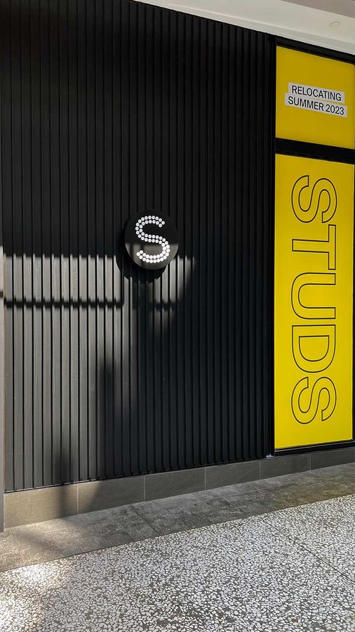 STUDS light box sign mounted on the wall