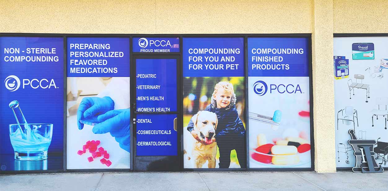 PCCA modern pharmacy exterior design with a blue advertising poster